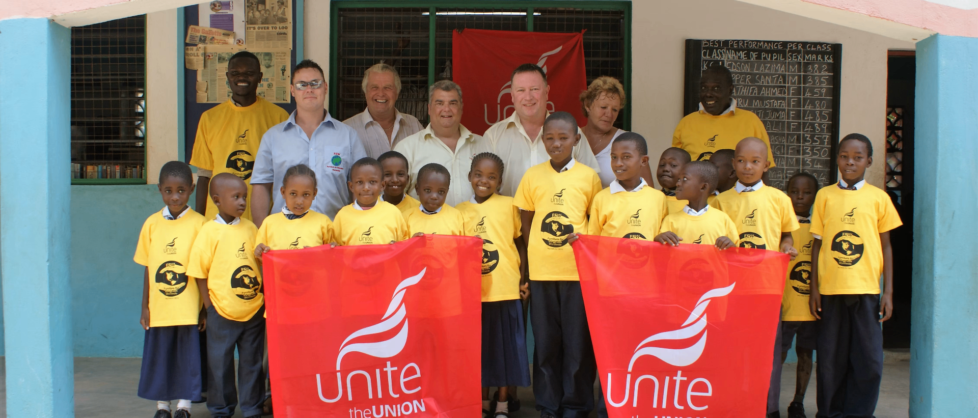FEW team and partner-school pupils outside a Gambian classroom